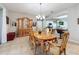 Dining room features wood table, built in cabinet, and pass-through to the kitchen at 4088 Kingsley St, Clermont, FL 34711