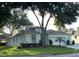 Charming single-story home featuring a well-maintained lawn and a two-car garage at 4088 Kingsley St, Clermont, FL 34711