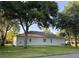 Well-maintained single-story home with a spacious backyard and mature trees, providing ample shade and privacy at 4088 Kingsley St, Clermont, FL 34711