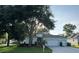 Charming single-story home with a well-manicured lawn and mature trees, offering shade and curb appeal at 4088 Kingsley St, Clermont, FL 34711