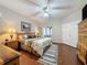 Spacious main bedroom with wood floors, ceiling fan, and large windows for natural light at 4088 Kingsley St, Clermont, FL 34711