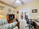 Functional home office setup with a workstation, sofa, and a glass panel door at 4088 Kingsley St, Clermont, FL 34711