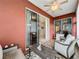 Relaxing enclosed patio with comfortable seating, ceiling fan and sliding glass doors to the interior at 4088 Kingsley St, Clermont, FL 34711