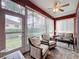 Bright sunroom featuring tile floors, ceiling fan, and expansive windows providing natural light and views at 4088 Kingsley St, Clermont, FL 34711