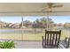 Screened balcony with rocking chairs and peaceful neighborhood views at 5279 Bowline Ct, Oxford, FL 34484