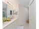 Bright bathroom features a double vanity with sleek fixtures at 5279 Bowline Ct, Oxford, FL 34484