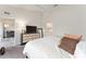 This bedroom includes a large dresser and an entrance to the bathroom and living room at 5279 Bowline Ct, Oxford, FL 34484