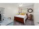 Cozy bedroom features a ceiling fan, a wooden bed frame, and neutral decor at 5279 Bowline Ct, Oxford, FL 34484