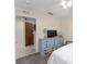 This bedroom features an blue dresser and an doorway view of the kitchen at 5279 Bowline Ct, Oxford, FL 34484