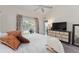 This bedroom includes a TV, dresser, entrance to a balcony at 5279 Bowline Ct, Oxford, FL 34484