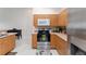Updated kitchen featuring stainless steel appliances, wooden cabinets, and tile flooring at 5279 Bowline Ct, Oxford, FL 34484