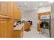 Bright kitchen showcasing natural wood cabinetry, modern appliances, and tile floors at 5279 Bowline Ct, Oxford, FL 34484