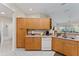 A kitchen with wooden cabinets, a white dishwasher, and tiled floors at 5279 Bowline Ct, Oxford, FL 34484