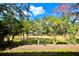 Large backyard features mature trees and landscaping, creating a private outdoor oasis at 119 Crescent Moon Dr, Groveland, FL 34736