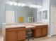Bathroom featuring dual vanities with ample counter space and a large mirror at 119 Crescent Moon Dr, Groveland, FL 34736
