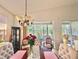 Charming dining area with stylish lighting and a sliding glass door at 119 Crescent Moon Dr, Groveland, FL 34736