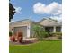 Charming single-story home featuring manicured landscaping and an attached two-car garage at 119 Crescent Moon Dr, Groveland, FL 34736