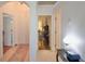 Hallway with tile floors provides access to the bedroom which has hardwood floors at 119 Crescent Moon Dr, Groveland, FL 34736