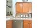 Bright kitchen features wooden cabinetry and stainless steel appliances for modern convenience at 119 Crescent Moon Dr, Groveland, FL 34736