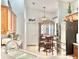 A well-lit kitchen featuring wood cabinetry, stainless steel appliances, and an adjacent dining area at 119 Crescent Moon Dr, Groveland, FL 34736