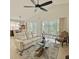 Bright living room with large windows, a ceiling fan, and a neutral color scheme at 119 Crescent Moon Dr, Groveland, FL 34736