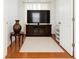 Bright living room with hardwood floors, a large TV, and ample natural light at 119 Crescent Moon Dr, Groveland, FL 34736