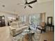 Bright living room with neutral colors, fan and large sliding doors to lanai at 119 Crescent Moon Dr, Groveland, FL 34736