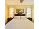 Comfortable bedroom with a four-poster bed, side tables with lamps, and soft natural light at 119 Crescent Moon Dr, Groveland, FL 34736