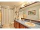 Well-lit bathroom with vanity, sink, and tub-shower combination at 13412 Fox Glove St, Winter Garden, FL 34787