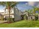 Charming two-story home with a well-manicured lawn and lush landscaping, including palm trees at 13412 Fox Glove St, Winter Garden, FL 34787