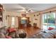 Comfortable living room with hardwood floors, a large entertainment center, and access to the pool area at 13412 Fox Glove St, Winter Garden, FL 34787