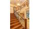 Elegant wooden staircase with decorative iron railings leading to the second floor at 13412 Fox Glove St, Winter Garden, FL 34787