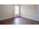 Bedroom features wood floors, neutral walls, and window with curtain at 1836 Ridge Valley St, Clermont, FL 34711