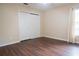Bedroom features wood floors, neutral walls, window with curtain, and closet with doors at 1836 Ridge Valley St, Clermont, FL 34711