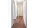 Hallway features wood floors, neutral walls, and doors leading to various rooms at 1836 Ridge Valley St, Clermont, FL 34711