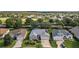 This aerial view shows a charming home with manicured lawn at 24124 Robinwood St, Leesburg, FL 34748