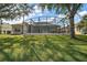 Spacious backyard featuring a screened pool area and lush green lawn at 24124 Robinwood St, Leesburg, FL 34748