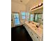 Updated bathroom featuring dual sinks, modern fixtures, and a glass enclosed shower at 24124 Robinwood St, Leesburg, FL 34748