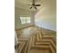 The spacious bedroom showcases beautiful parquet floors and a bright, sunny window at 24124 Robinwood St, Leesburg, FL 34748
