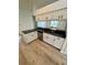 Bright kitchen featuring updated cabinetry, granite countertops, stainless steel dishwasher and flooring at 24124 Robinwood St, Leesburg, FL 34748