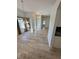 Open dining and living area features modern floors, chandeliers, windows, and glass doors to the exterior at 24124 Robinwood St, Leesburg, FL 34748