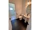 Cozy powder room includes a pedestal sink, a toilet, and a small mirror at 24124 Robinwood St, Leesburg, FL 34748