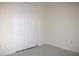 Bedroom featuring large closet with bi-fold doors and marble-look tile flooring at 840 Oaks Shores Rd, Leesburg, FL 34748