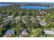 Expansive aerial view of a lakeside community surrounded by lush greenery and serene blue waters at 1405 Hilltop Dr, Mount Dora, FL 32757