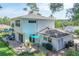 Outdoor patio with seating and dining space in the landscaped backyard at 1405 Hilltop Dr, Mount Dora, FL 32757