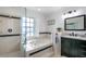Bathroom features a soaking tub with tile surround, separate glass enclosed shower, and updated vanity at 1405 Hilltop Dr, Mount Dora, FL 32757