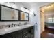 Bathroom boasts a double vanity, ample countertop space, updated fixtures and view to the bedroom at 1405 Hilltop Dr, Mount Dora, FL 32757