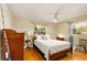Bright bedroom with wood floors, large windows, and neutral colored walls with furnishings at 1405 Hilltop Dr, Mount Dora, FL 32757