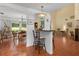 Open-concept living area with terracotta tile floors and bar seating at 1405 Hilltop Dr, Mount Dora, FL 32757