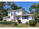Two-story home with a manicured lawn and mature landscaping at 1405 Hilltop Dr, Mount Dora, FL 32757